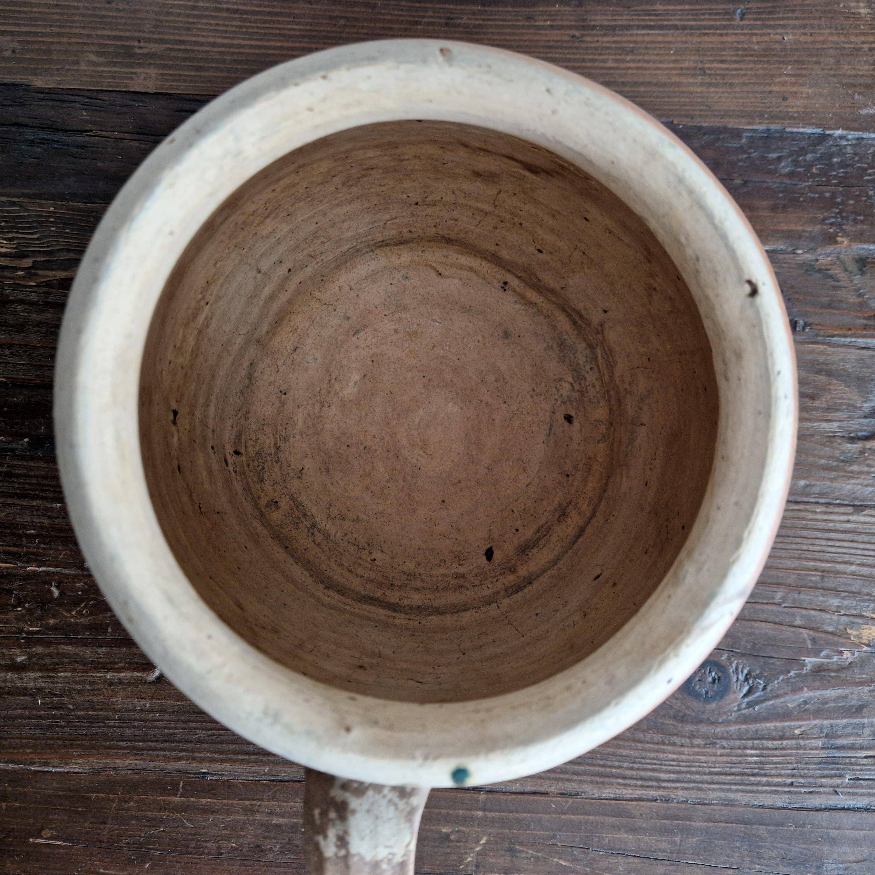 Ancient terracotta pot with a handle