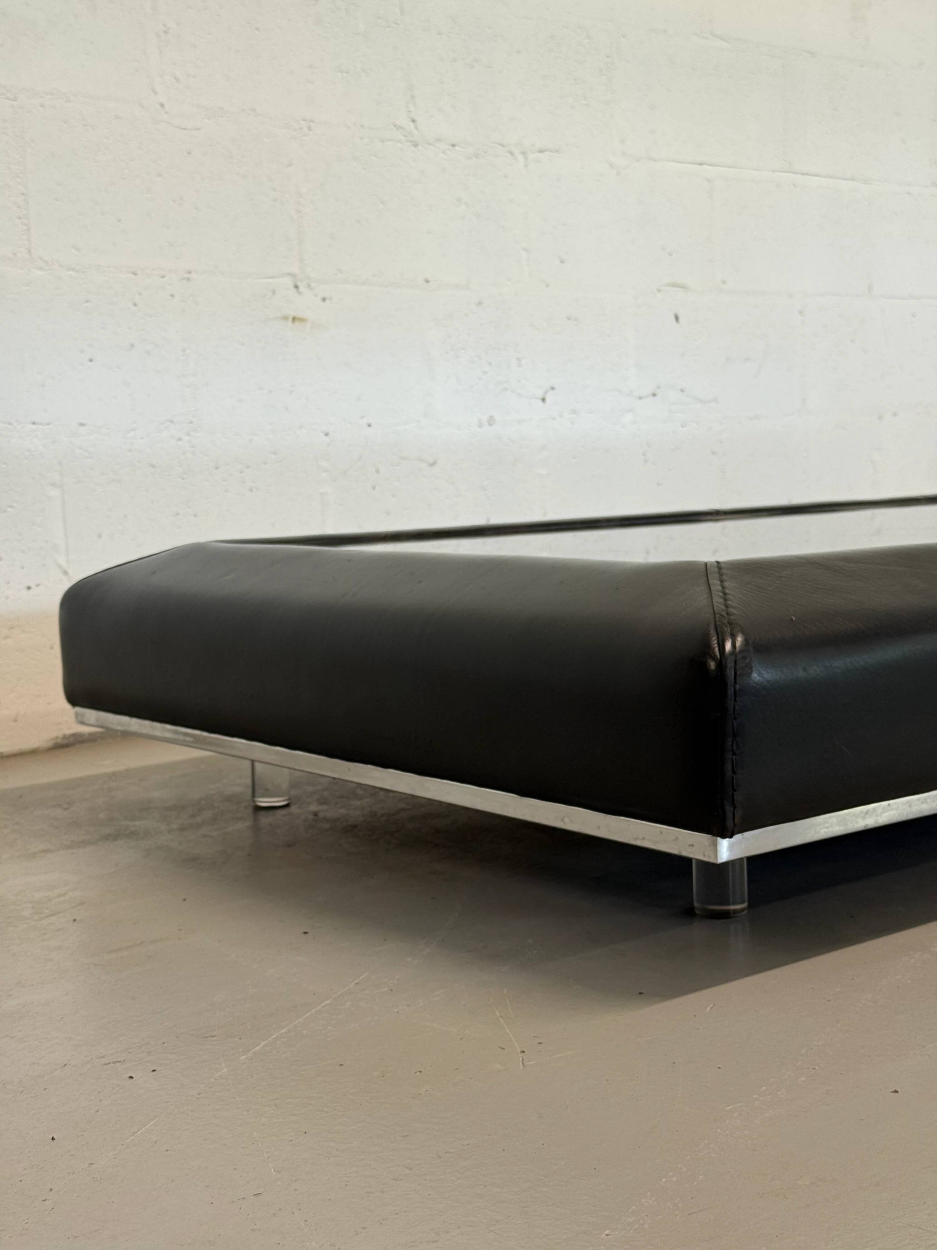 Vintage coffee table covered in leather, smoked mirror top and chrome legs.