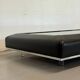 Vintage coffee table covered in leather, smoked mirror top and chrome legs.
