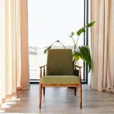 Mid-century modern armchair in olive green bouclé design by H. Lis.