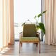 Mid-century modern armchair in olive green bouclé design by H. Lis.