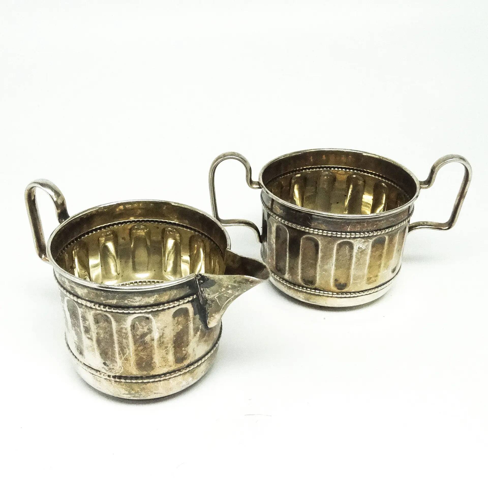 Set of sugar bowl and milk jug, neoclassicism with art deco influences, silver-plated brass, Belgium, 1930s.