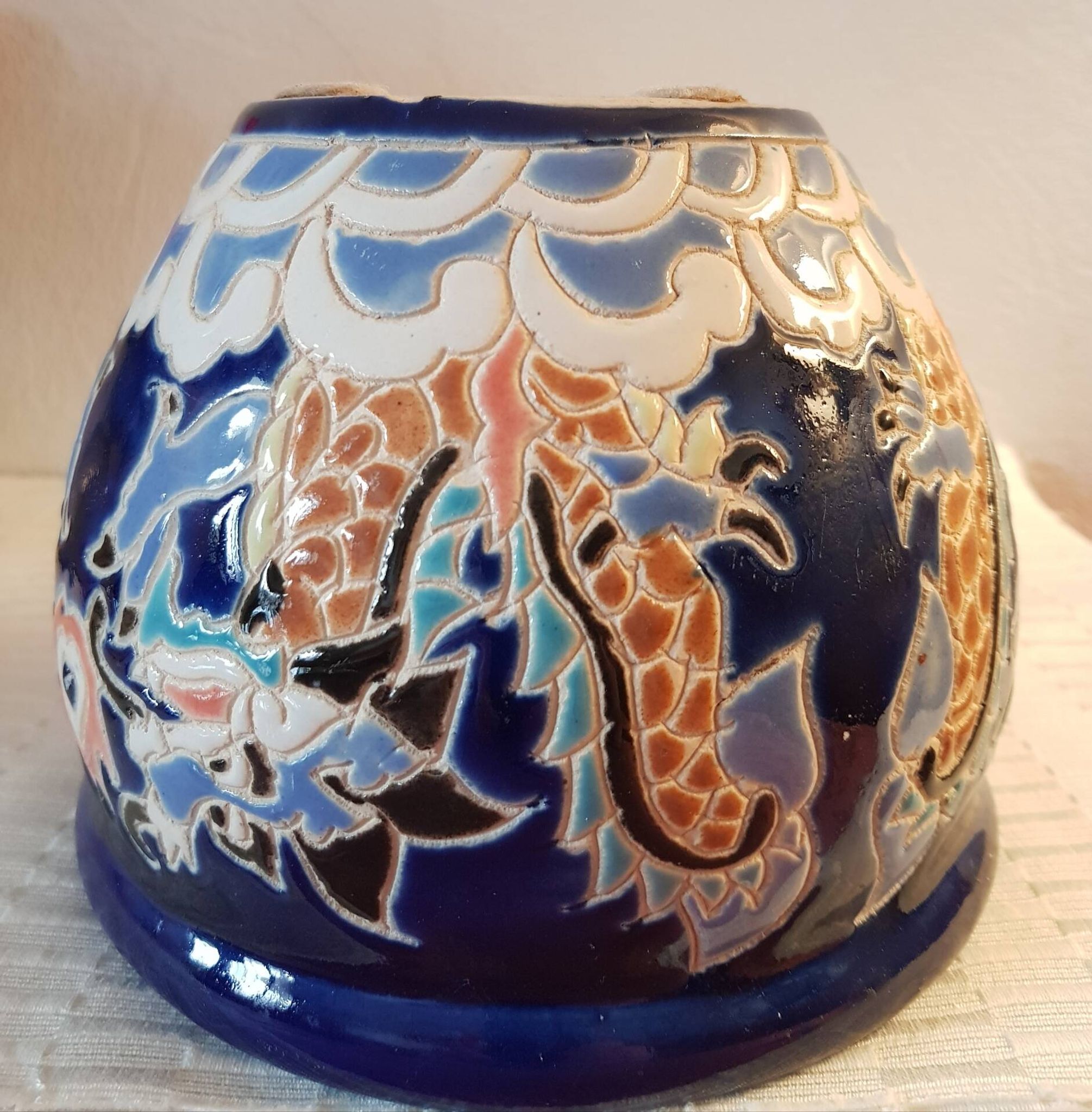 Decorative pot in multicoloured relief glazed ceramic.