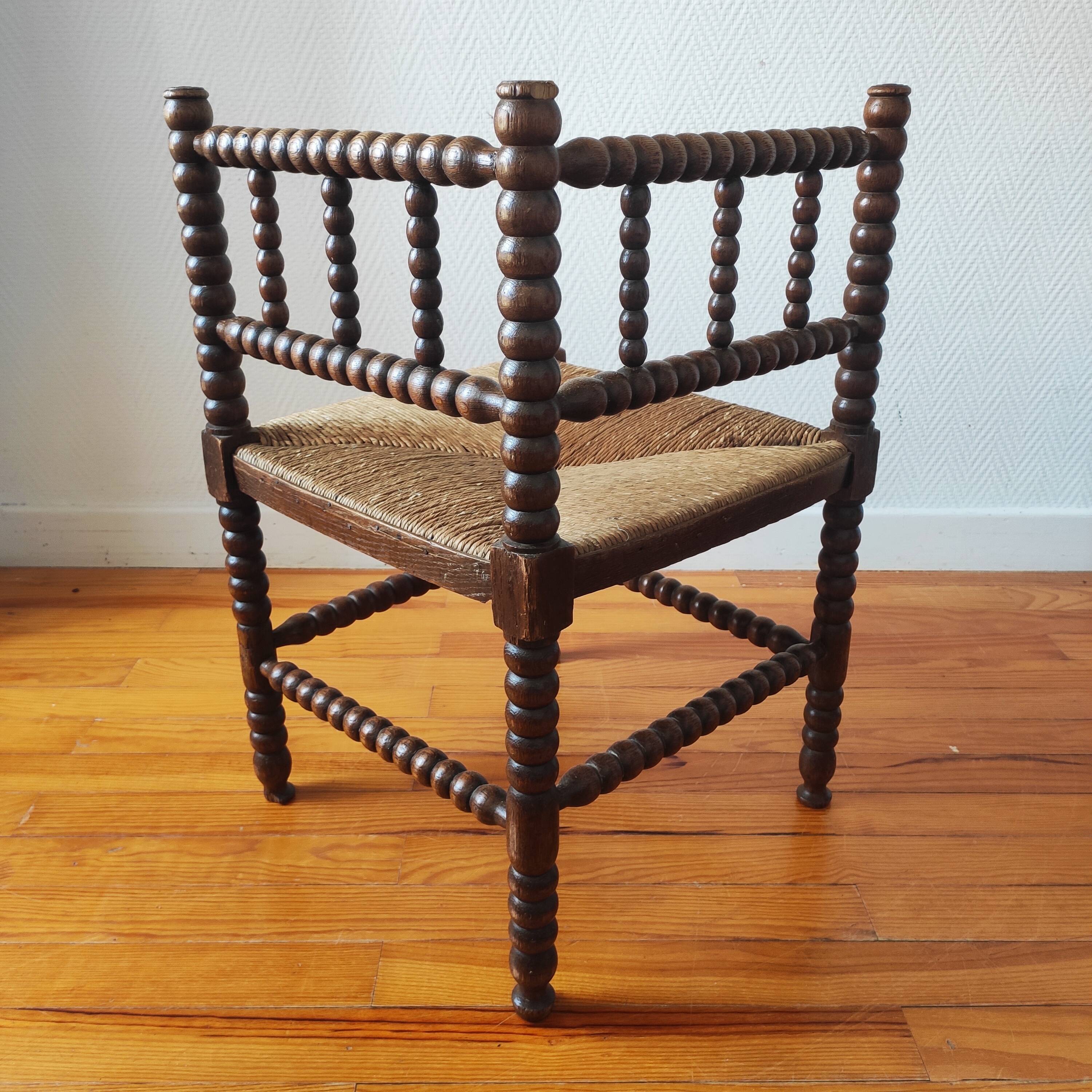 Antique corner chair made of turned wood spindle.