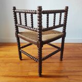 Antique corner chair made of turned wood spindle.