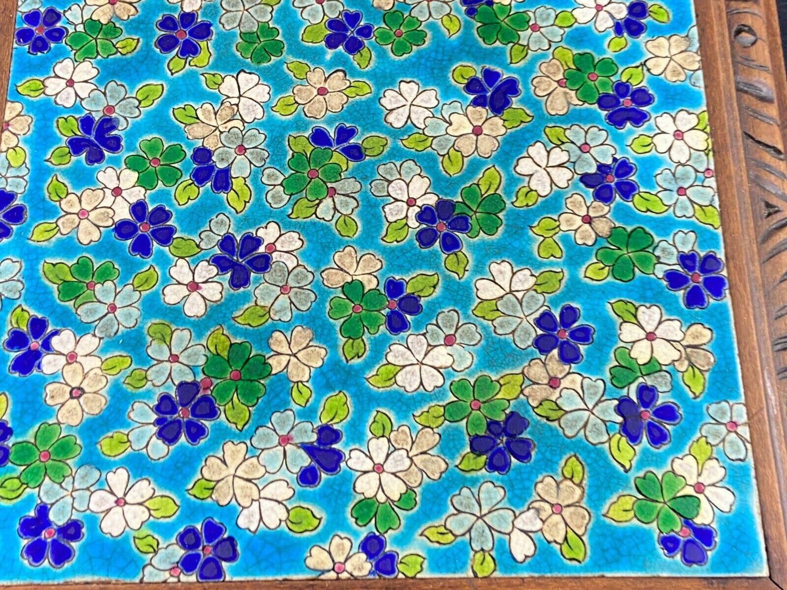 Longwy earthenware trivet on wooden mount, early 20th century