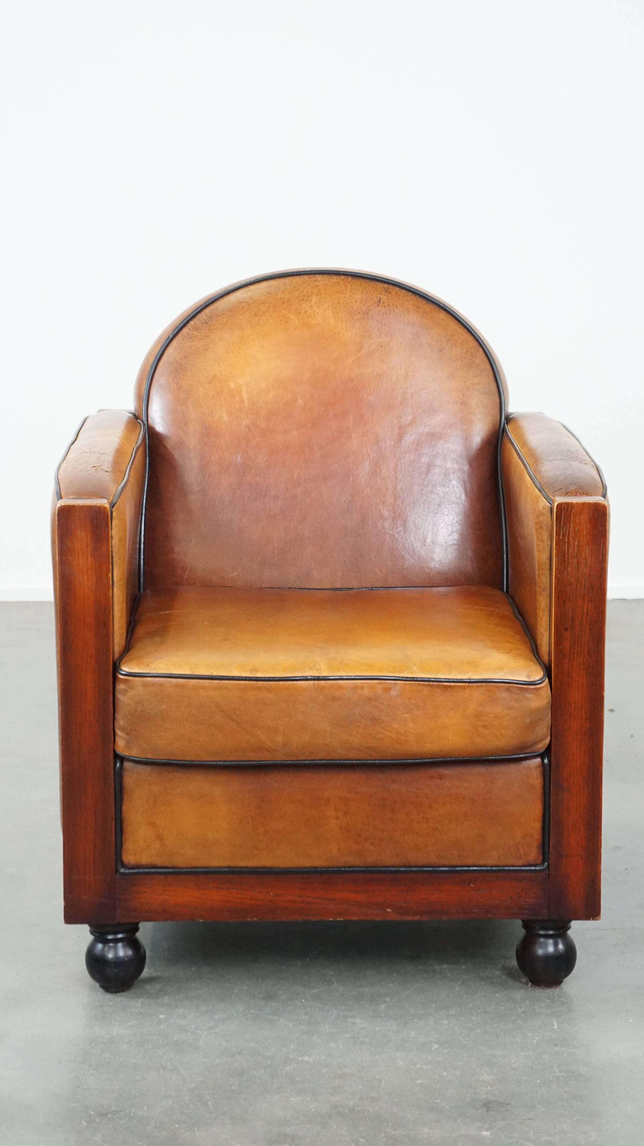Sheep leather and wooden Art Deco design armchair with ball feet