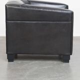 Very comfortable black Art Deco design armchair, made of sheepskin leather