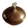 Empty pocket with copper or brass lid. Eagle at the top.