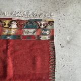 Small wool rug, predominantly red with geometric patterns
