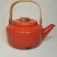 Orange and bamboo enamelled metal teapot in the 1970s