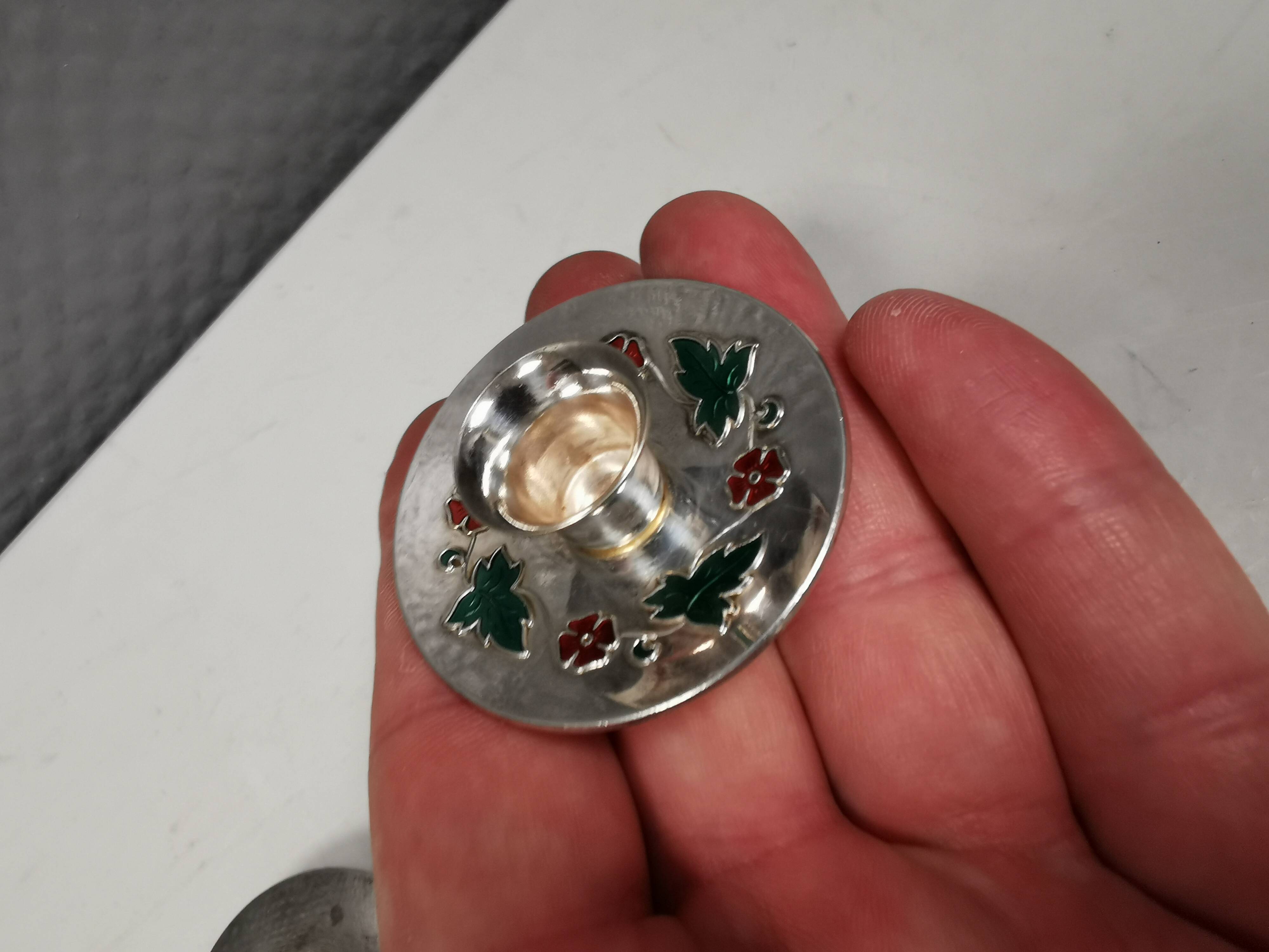 Silver-plated candle holders with inlaid red and green enamel
