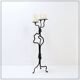 Large wrought iron candelabrum with an abstract design and three candle holders.