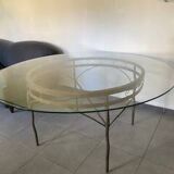 Round table with glass top and ornate metal base