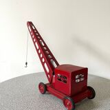 Red sheet metal construction crane dating from the 60s with manual mechanism