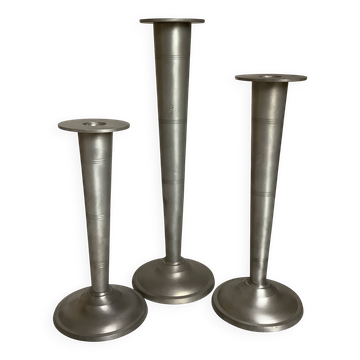Trio of asymmetrical cone-shaped candlesticks