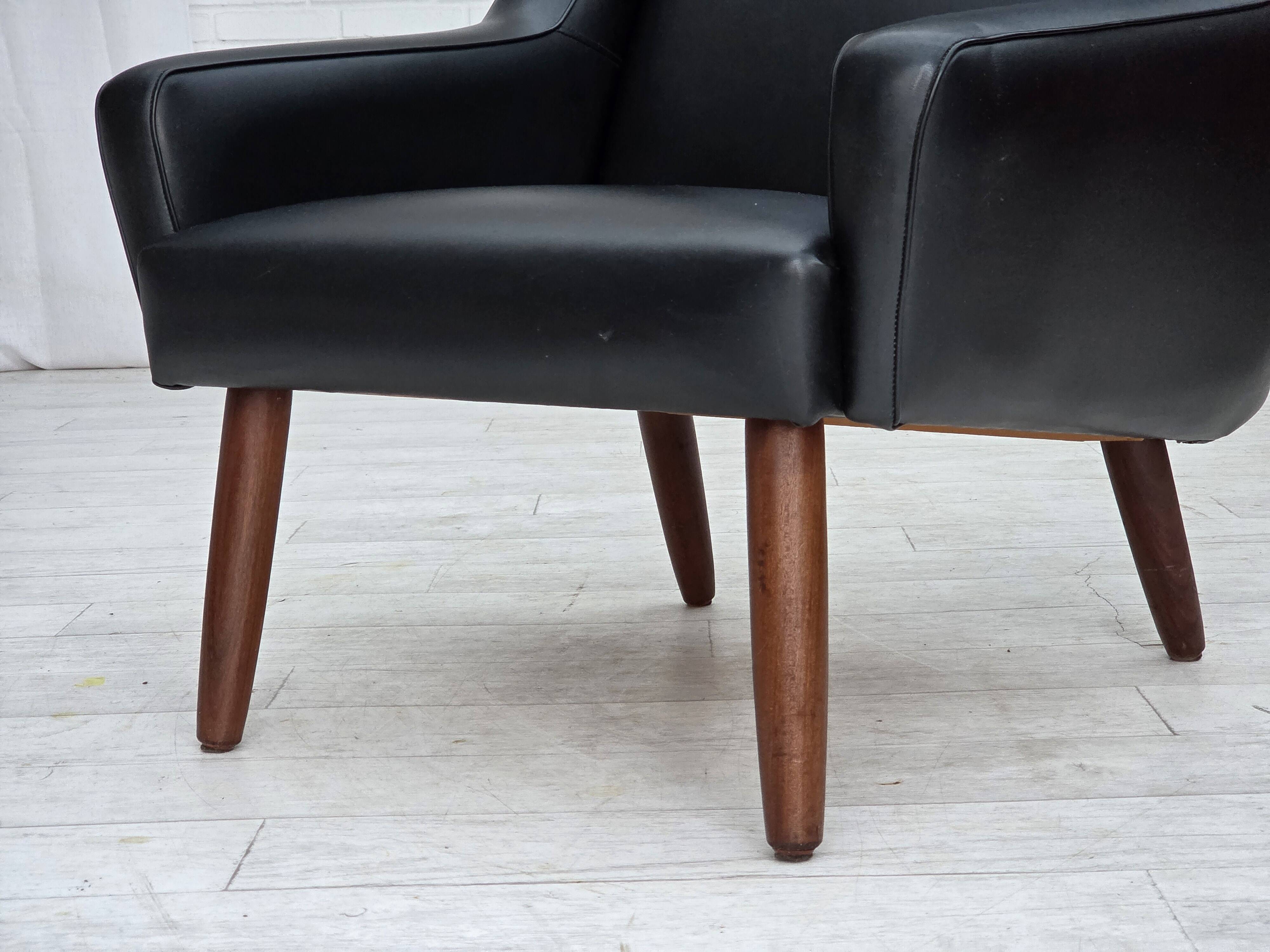 1970s, Danish highback armchair, black artificial leather, teak wood legs.