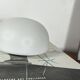 Small antique ceiling light or wall sconce with a frosted white glass half-moon.