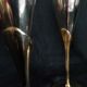 Lot of 12 silver metal flutes on brass stand