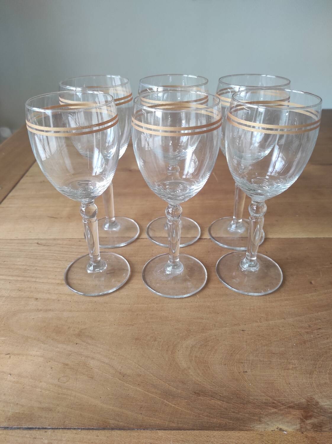 Set of 6 glasses with gold band decorations.