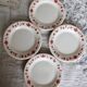 4 vintage porcelain dessert plates with red border and breakfast motif