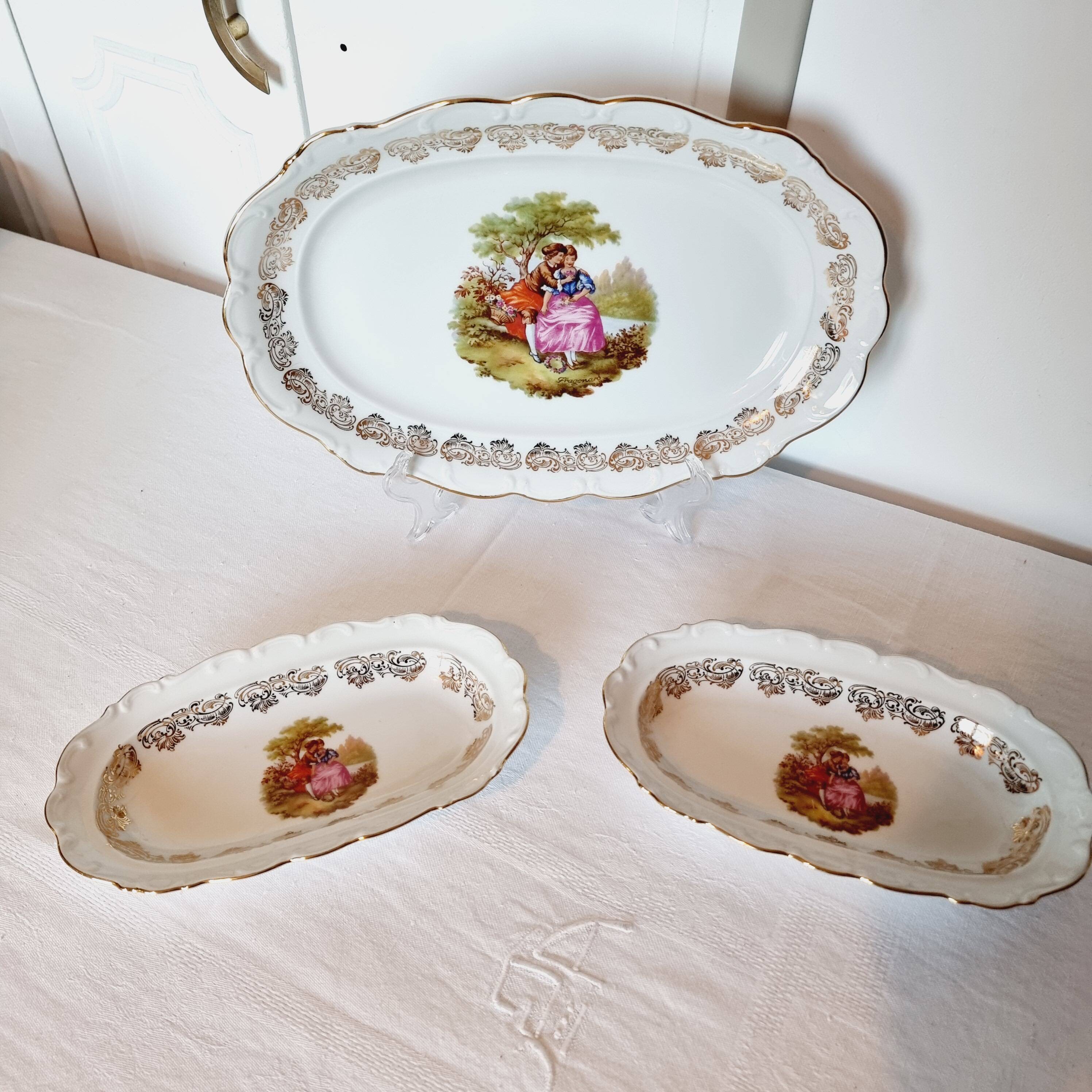 3 serving dishes with frangonard romantic scene with designs and borders in 24 carat gold.