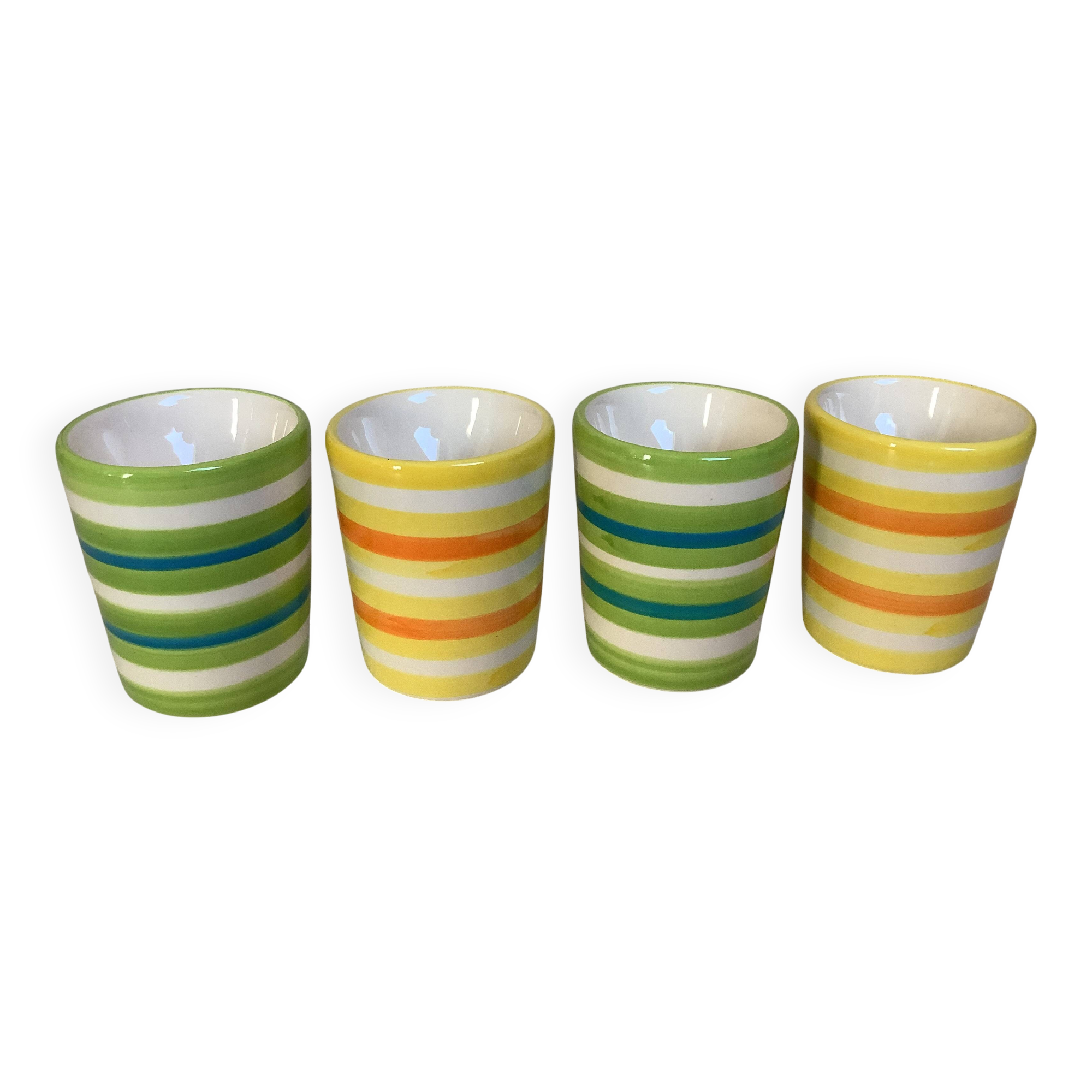 Four striped egg cups in yellow and green.