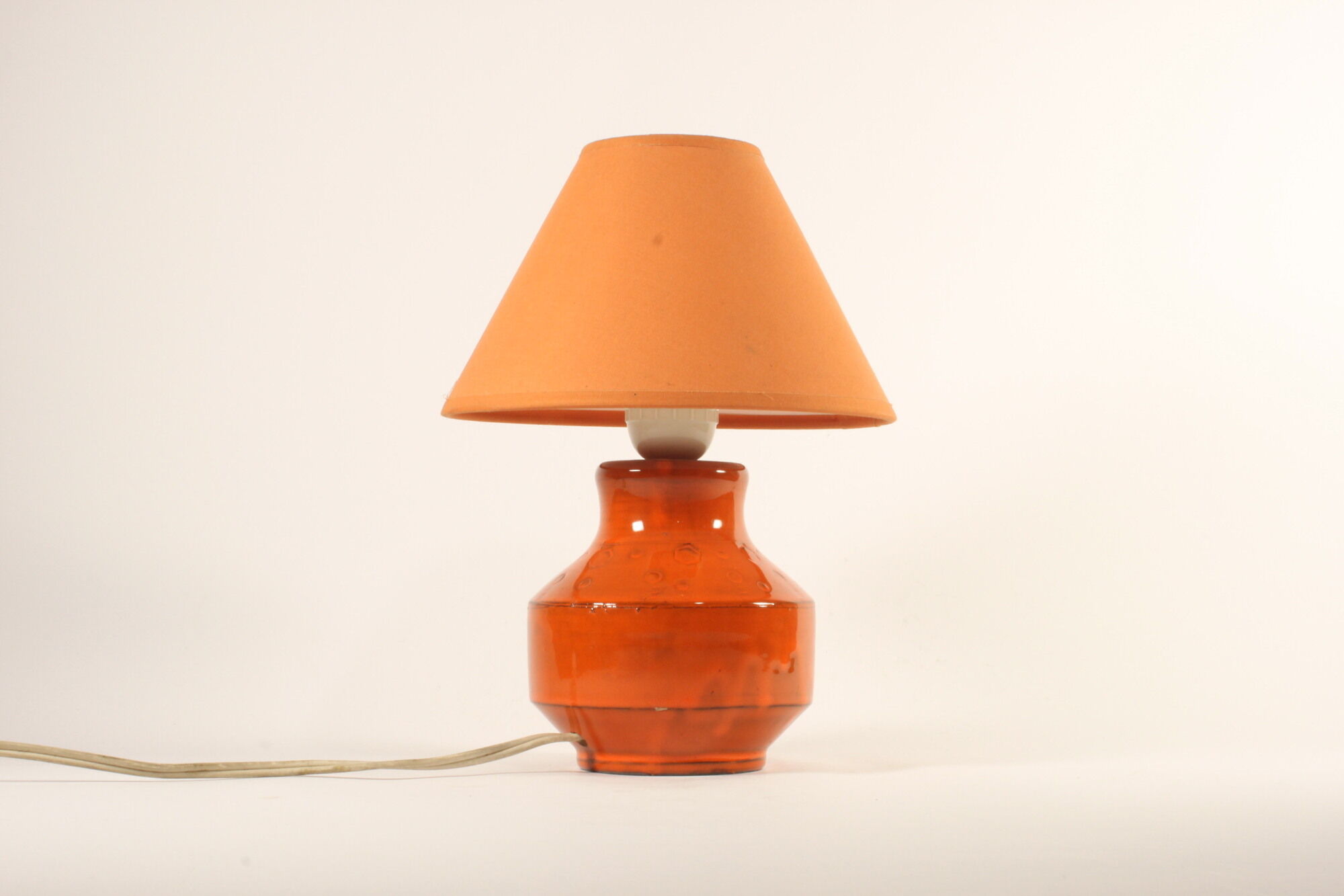 Orange ceramic table lamp with geometric imprints, 1970s.