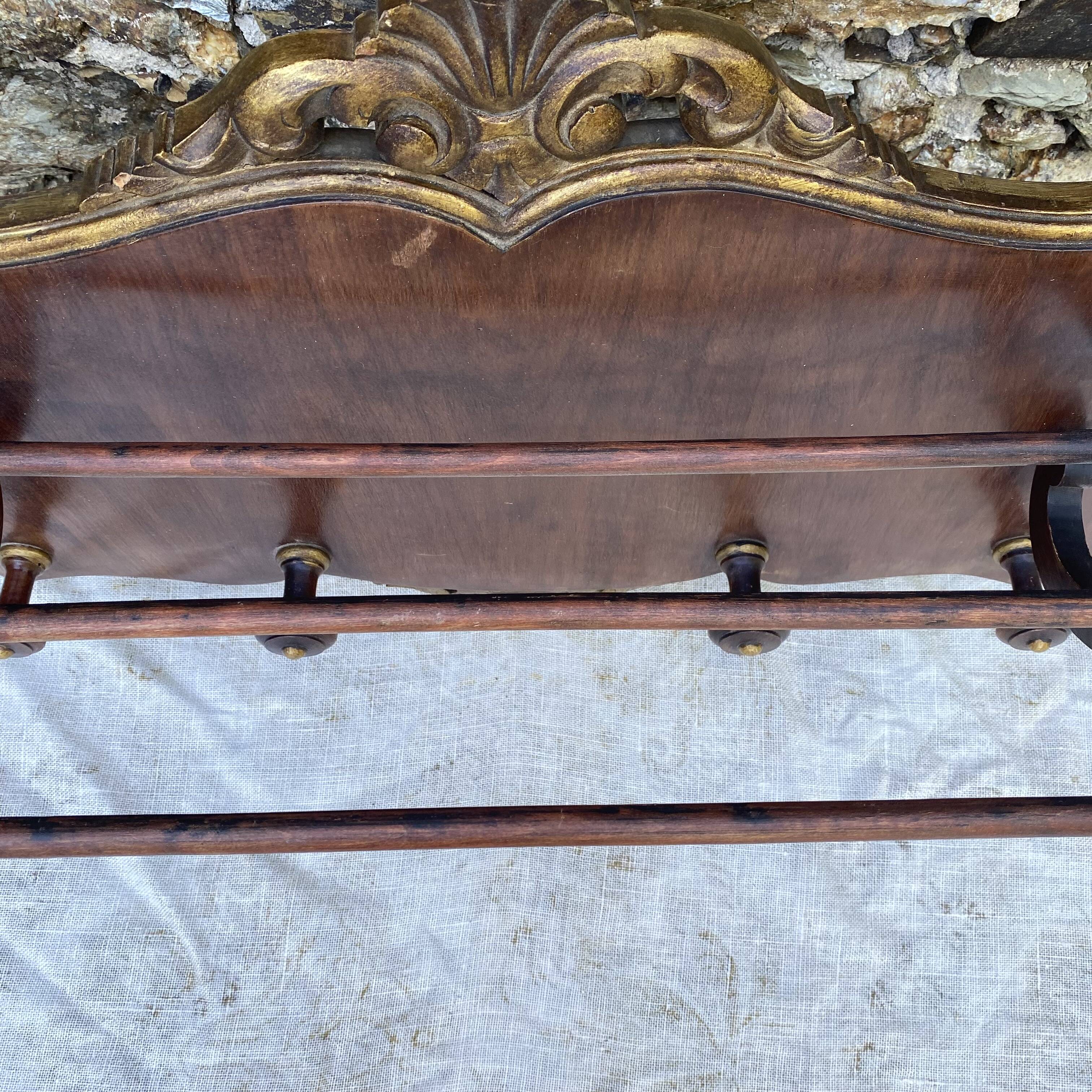 Coat rack and wall-mounted hat rack in an antique style.