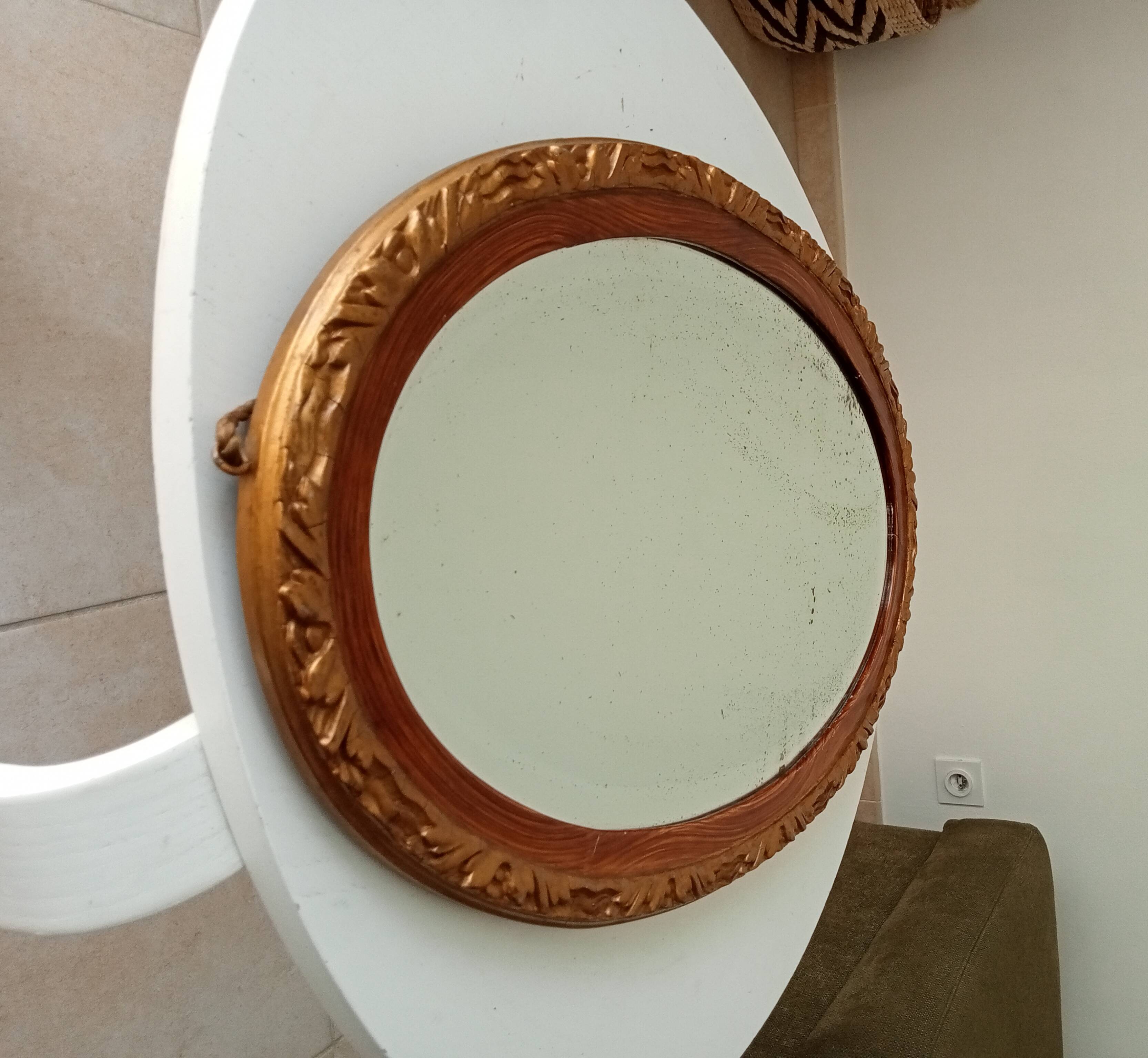 Antique oval mirror with beveled glass in wood and stucco, 19th century