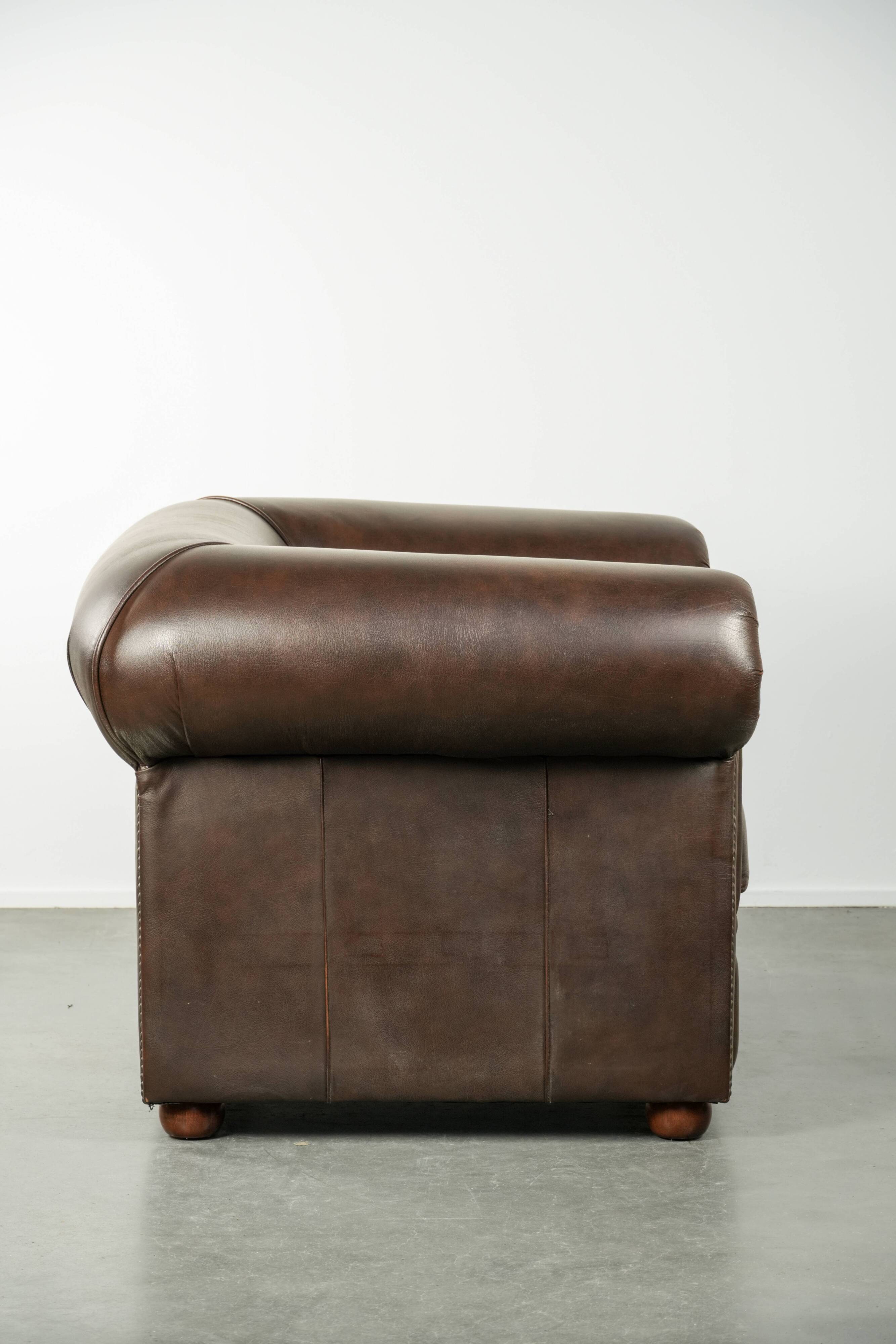 Set of a smooth chesterfield sofa and armchair with a timeless English look
