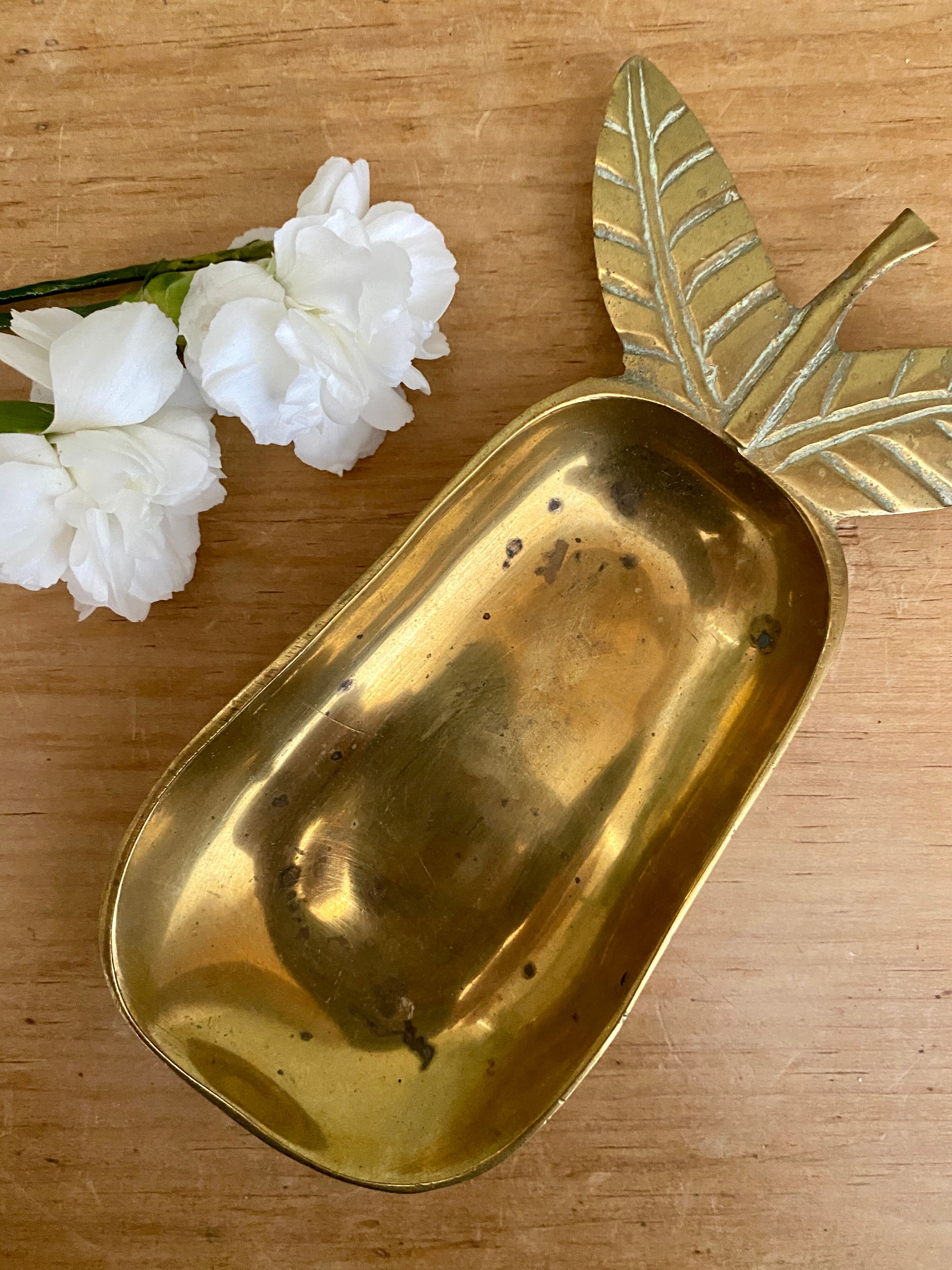 Empty vintage pear-shaped brass pocket