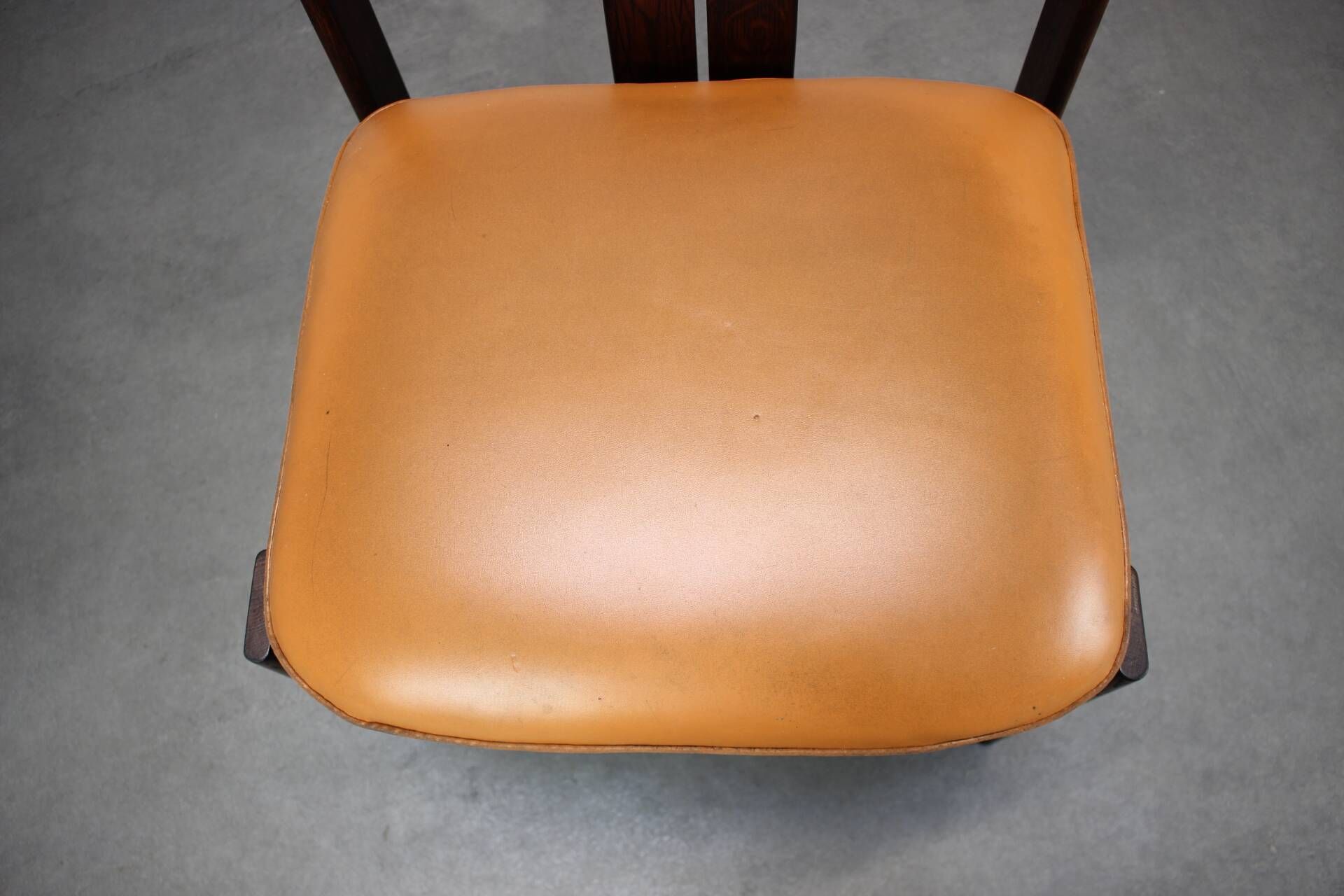 Vintage German sculptural chair from the 1970s in wood with orange faux leather.