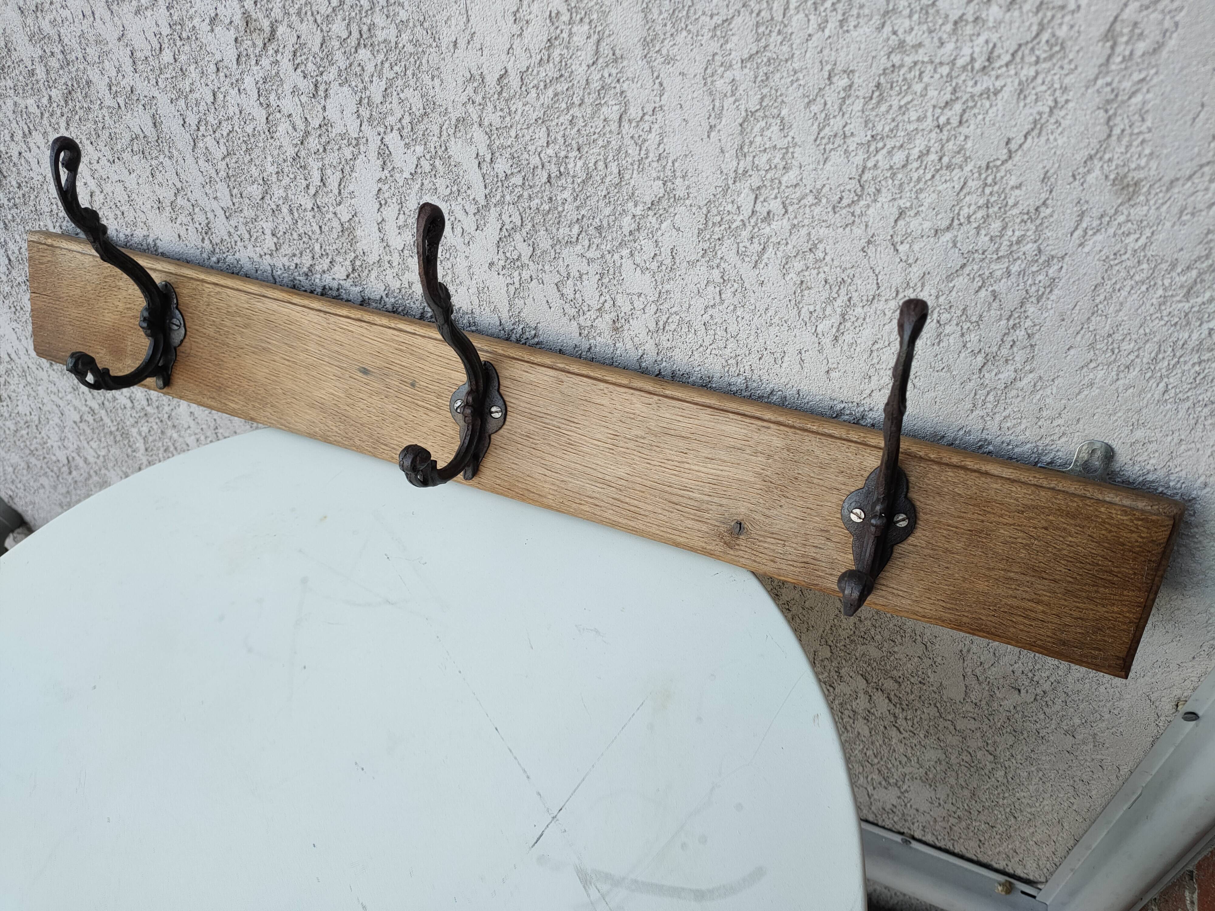 antique coat rack with 3 cast iron hooks