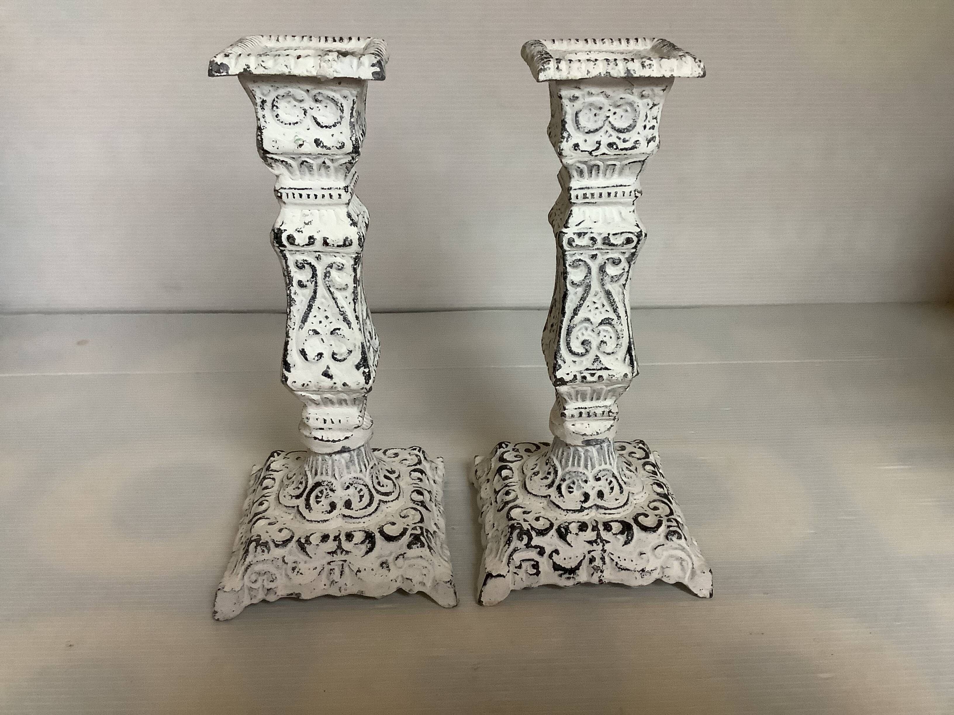 Pair of patinated cast iron candlesticks