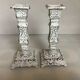 Pair of patinated cast iron candlesticks