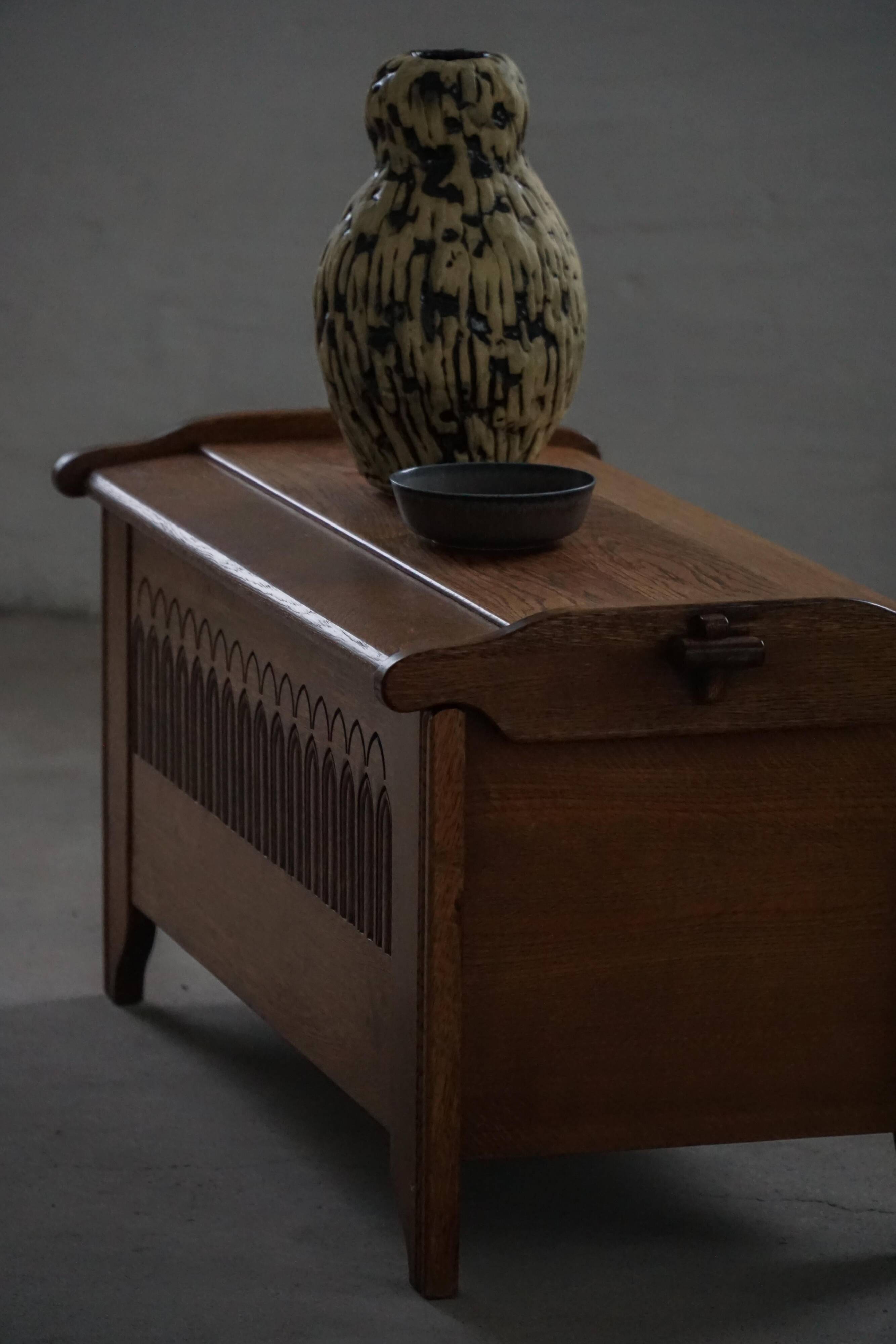 Modern Danish oak commode with decorative relief sculpture, mid-20th century.