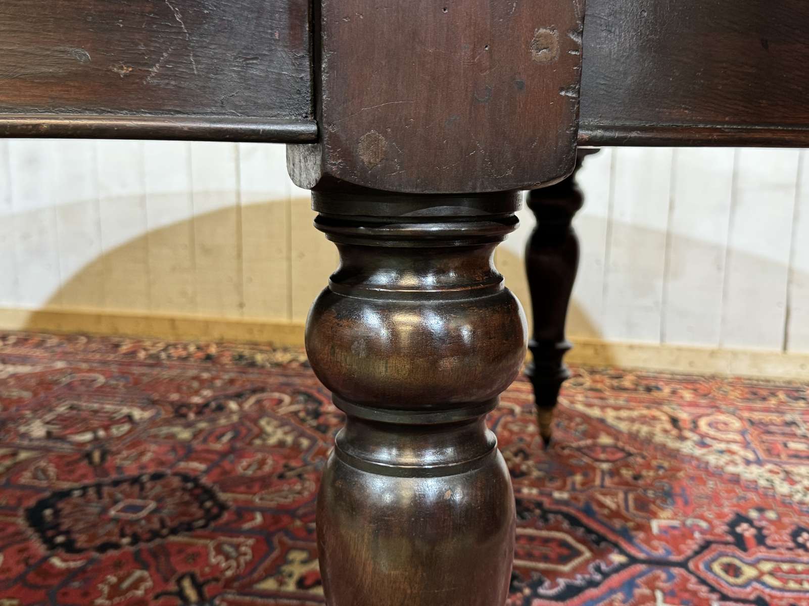 Large English library table in dark walnut with a leather top.