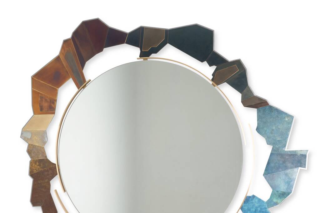 Contemporary mirror in oxidized bronze and brass with a deconstructed shape.