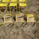 Lot of 11 yellow metallic bistro chairs from the 1950s