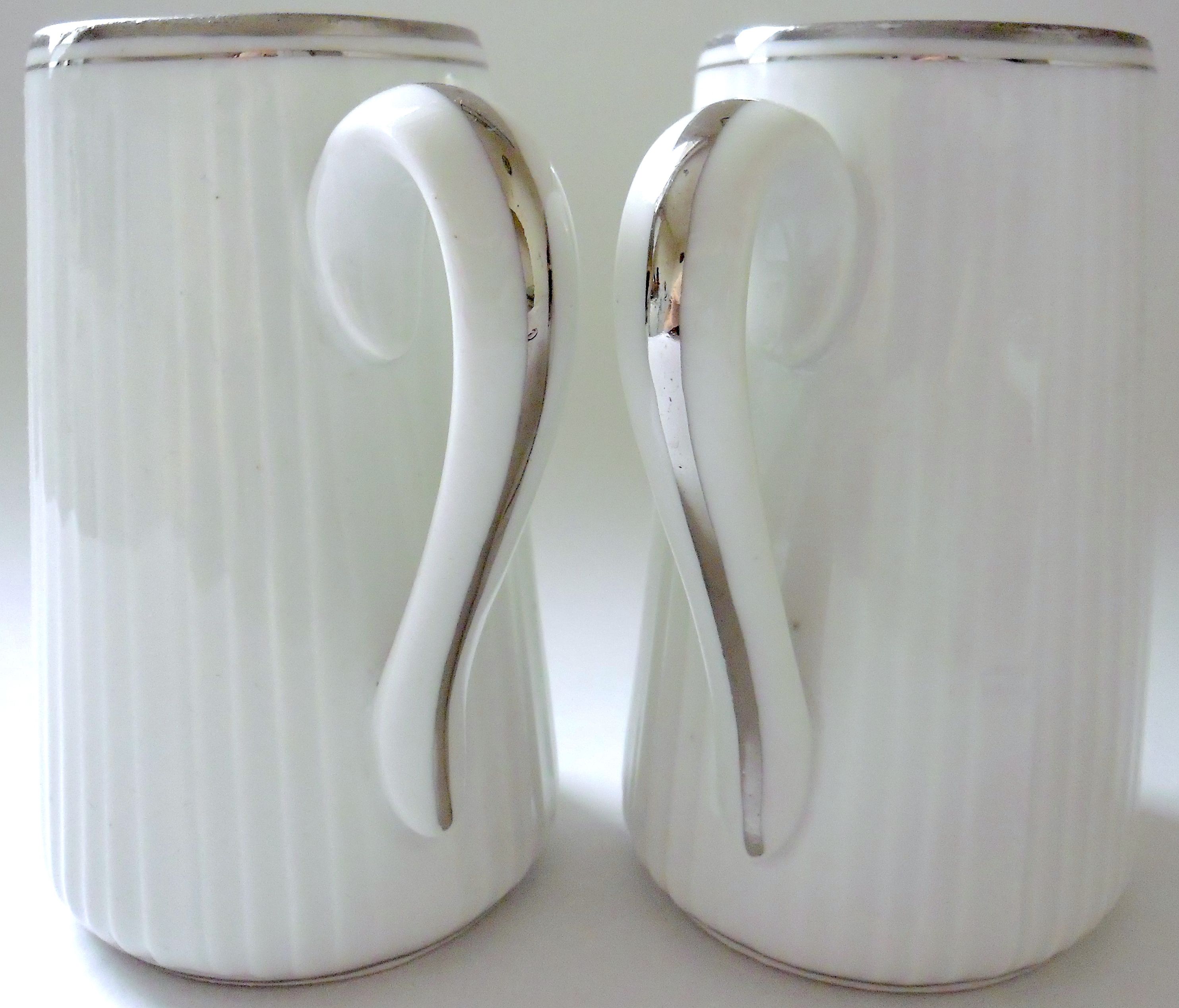 Pair of creamers in white porcelain enhanced with platinum