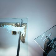 2 brutalist steel side tables with primitive  scene motifs etched glass