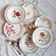 Mismatched old soup plates accompanied by a soup tureen