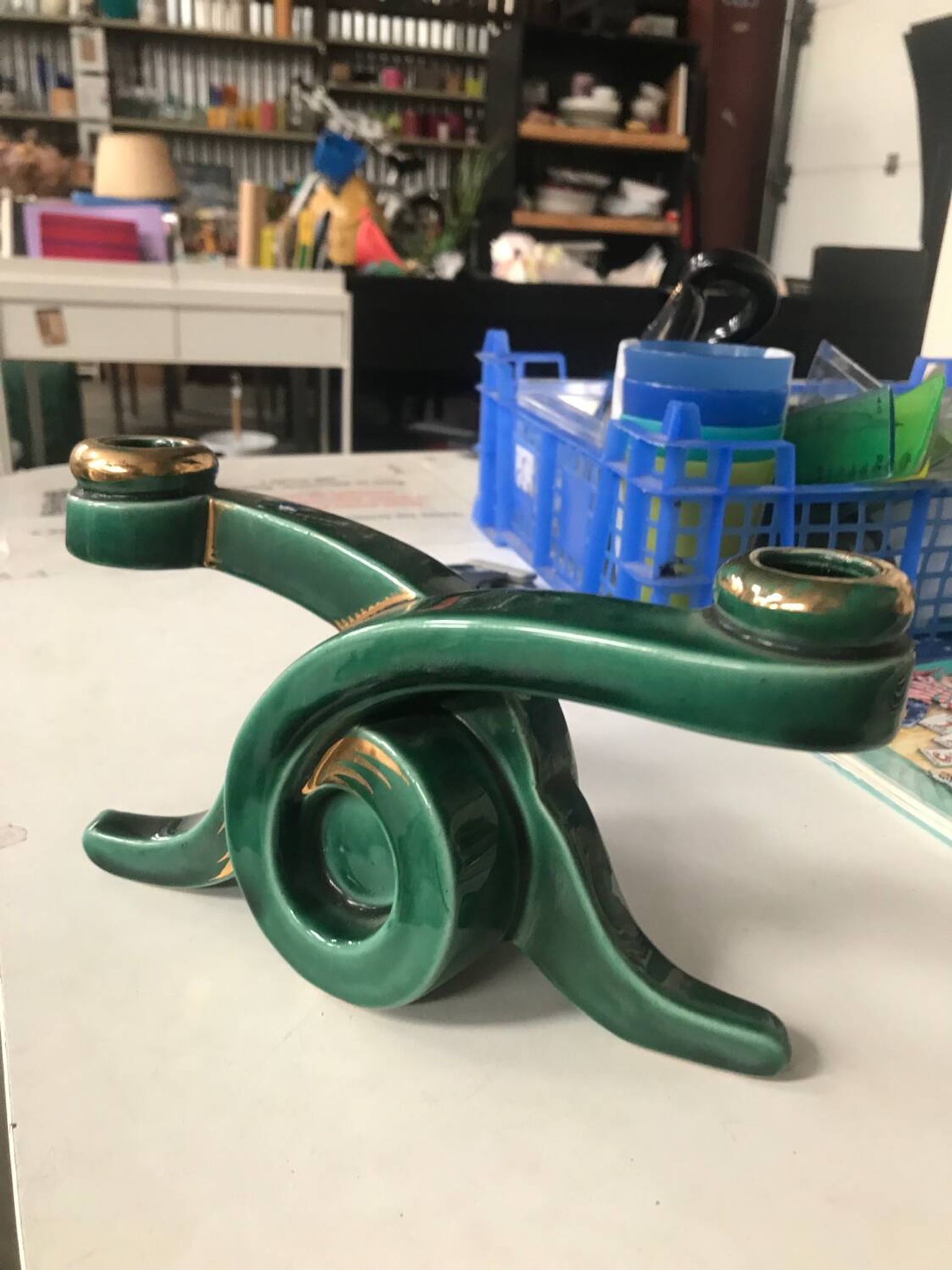 Art Deco candlestick in green and gold earthenware.