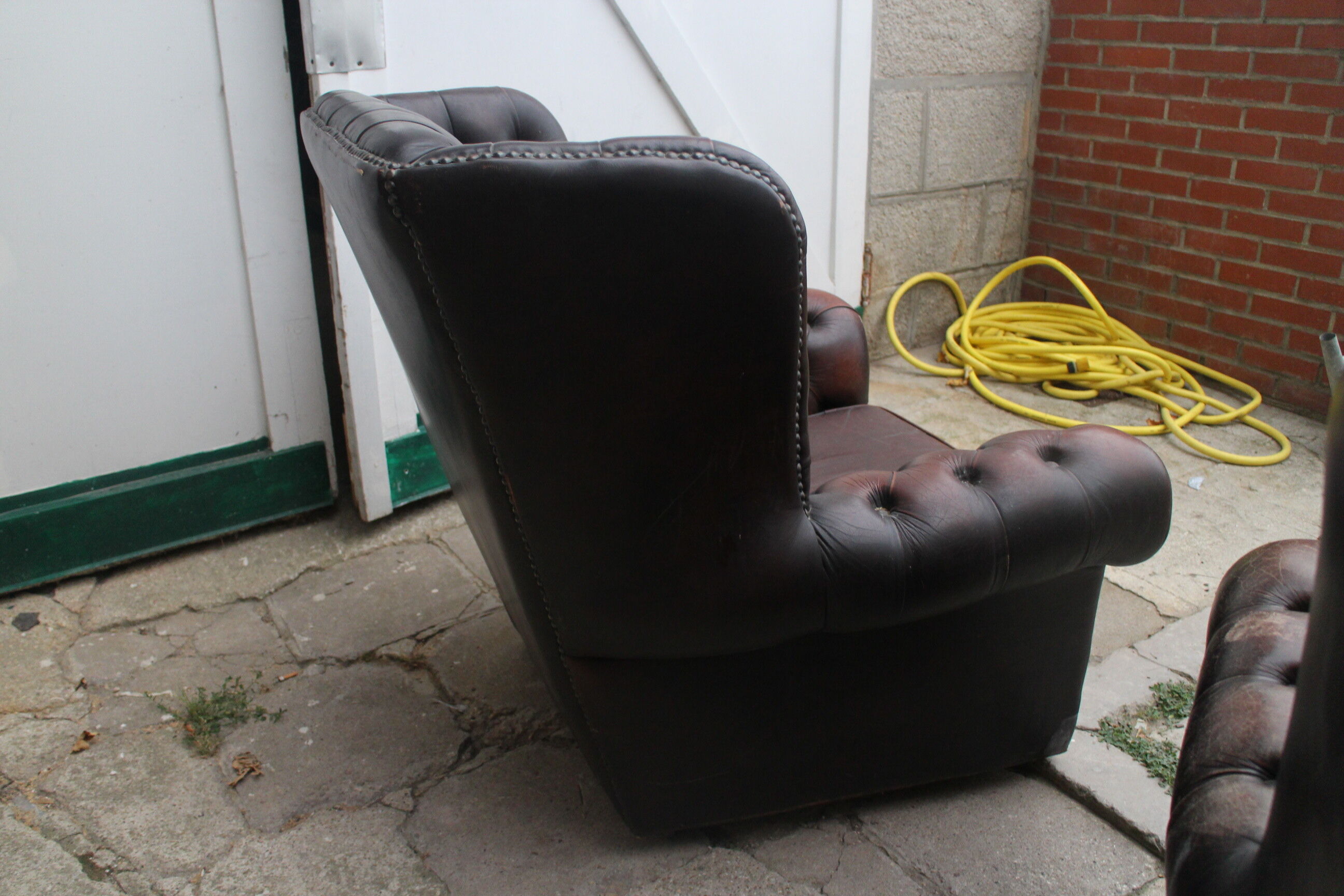 Padded chesterfield leather armchairs