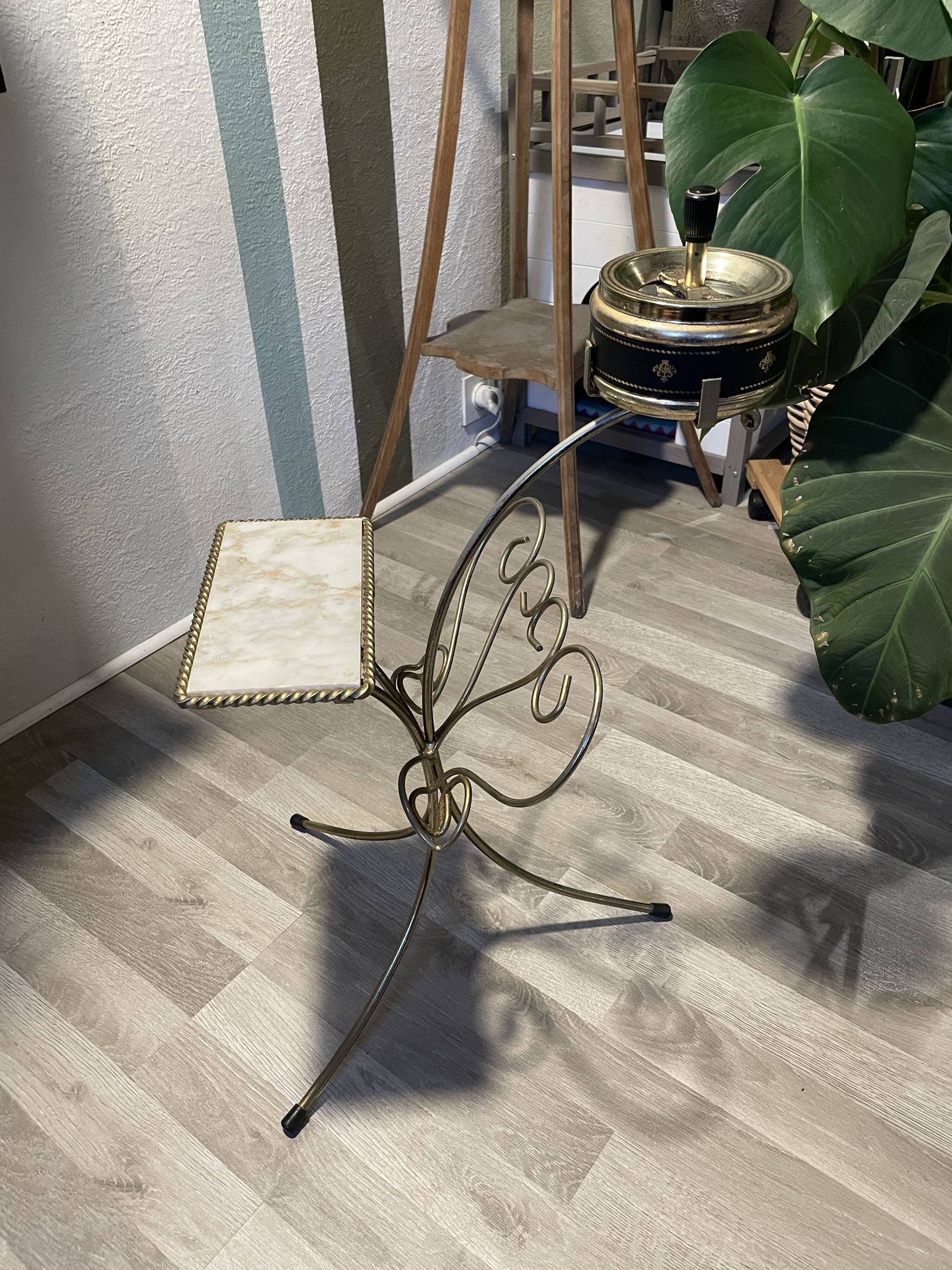 Gold wrought iron ashtray on legs with magazine rack and marbled shelf
