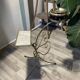 Gold wrought iron ashtray on legs with magazine rack and marbled shelf