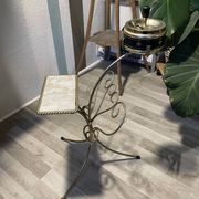 Gold wrought iron ashtray on legs with magazine rack and marbled shelf