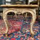 Louis XV style coffee table in carved wood with grey and gold highlights.