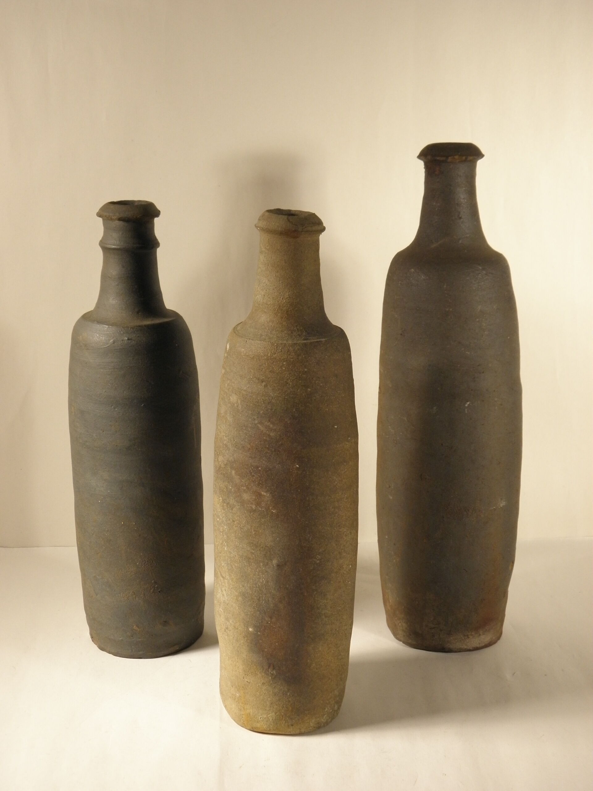 Three old sandstone bottles